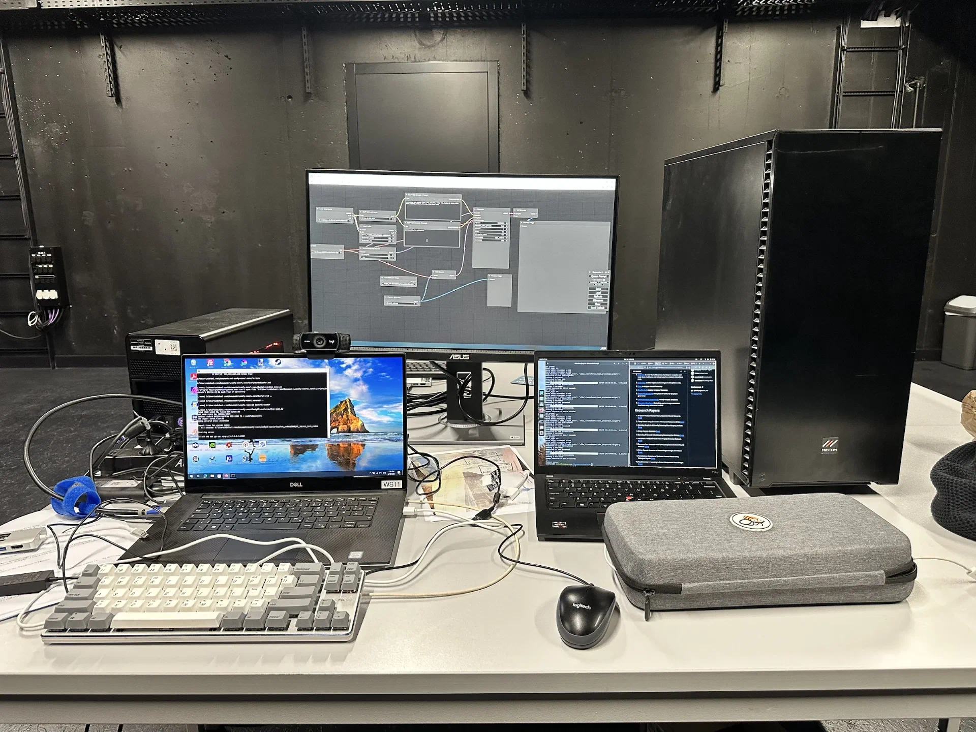 A development workstation runs code and a node-based image-processing interface across three displays.