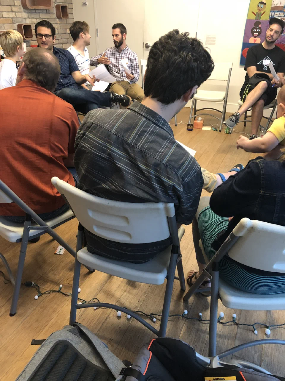 Participants sit in a close circle during an Austin presentation of The Group.